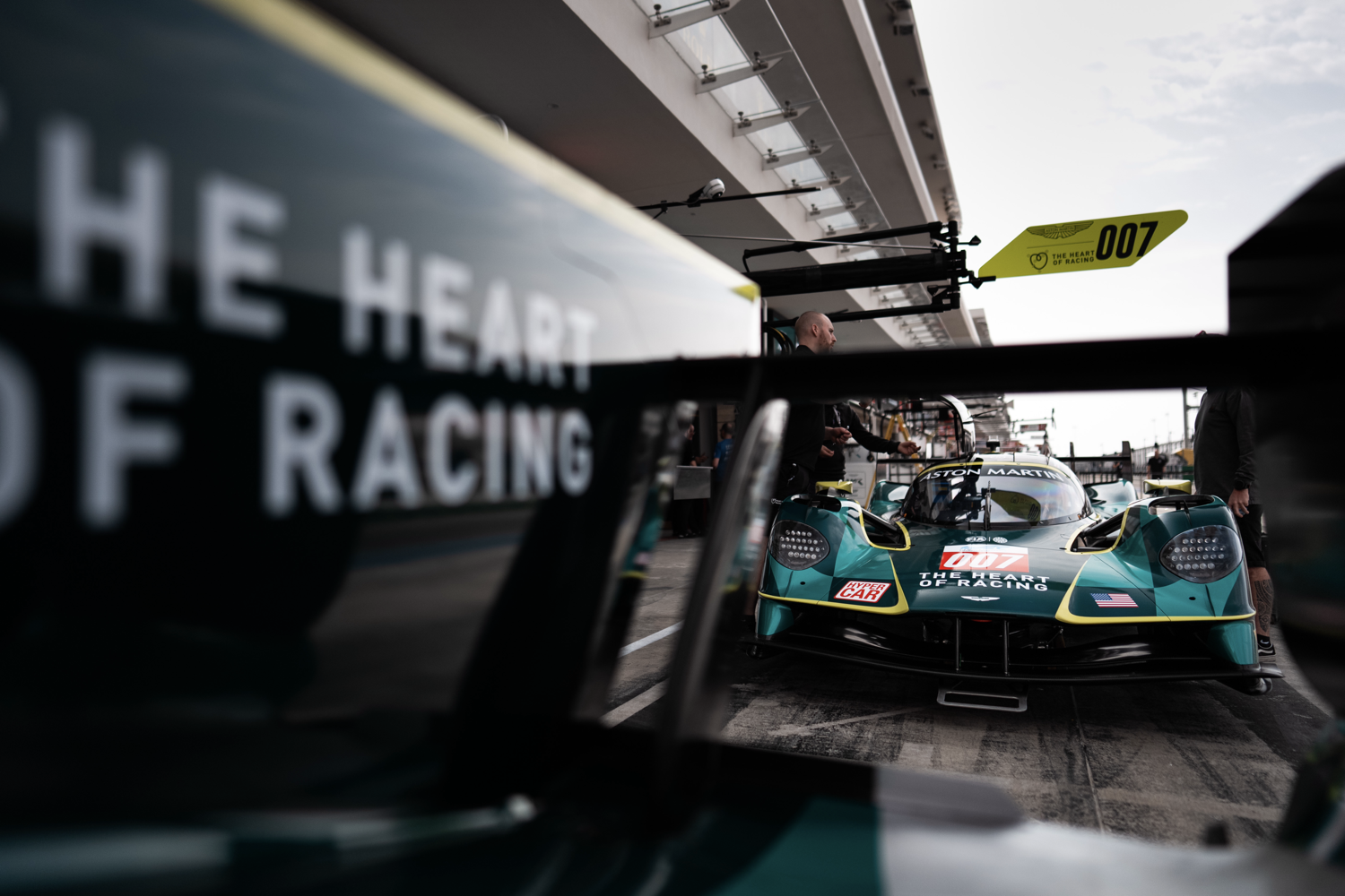 The #007 Aston Martin Valkyrie in the pits at Qatar's Lusail International Circuit, in daylight.