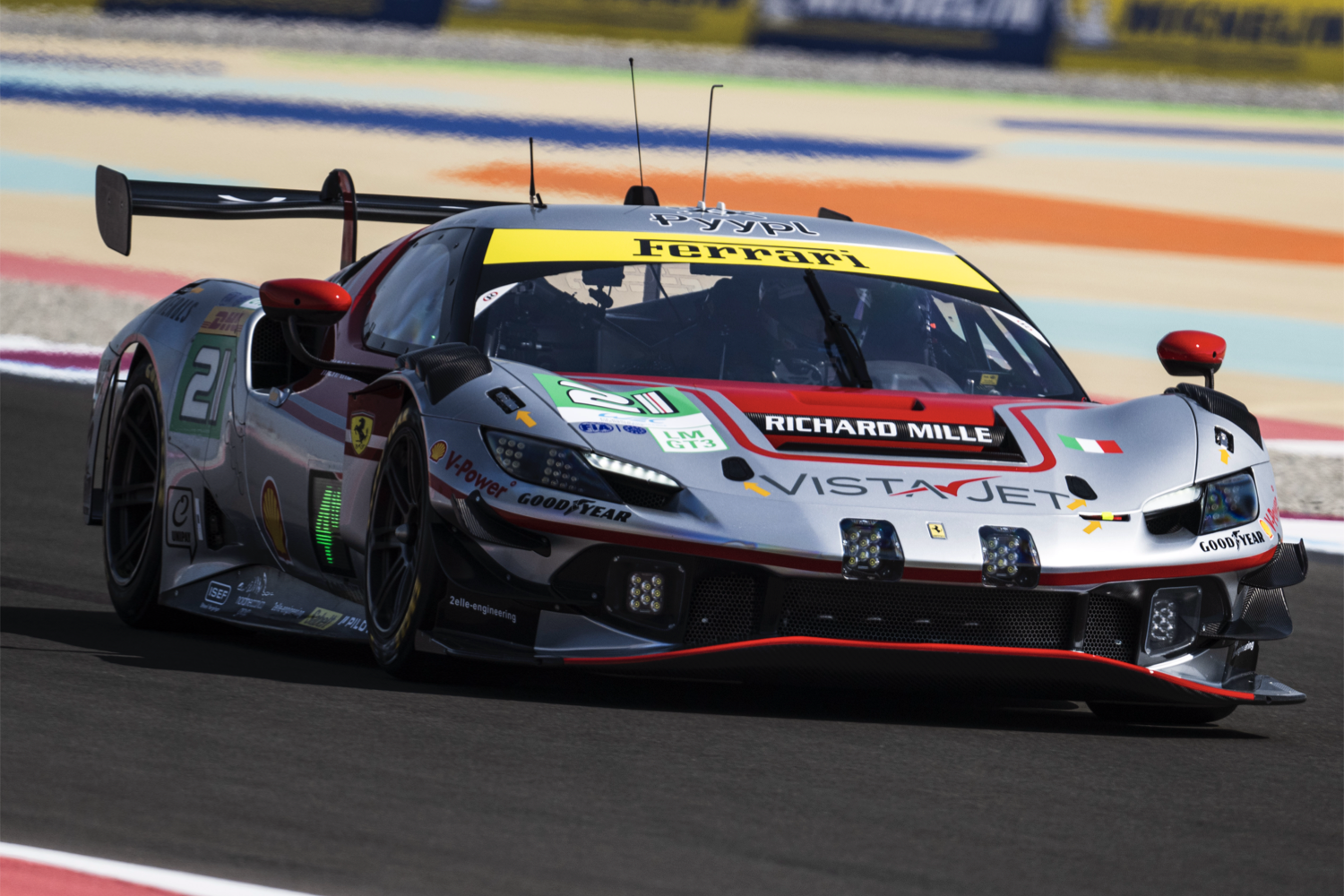 The #21 Vista AF Corse Ferrari 296 GT3 at Qatar's Lusail International Circuit, in daylight.