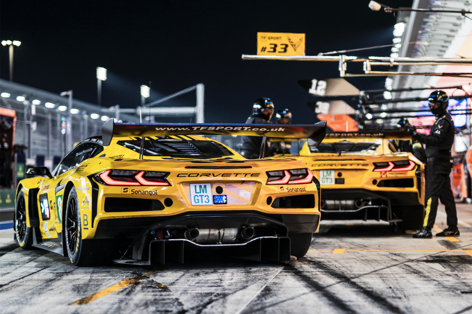 The two Corvettes Z06 GT3.Rs in the pits at Qatar's Lusail International Circuit, with one facing the 'fast lane' and the other in its pitstall.